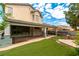 Spacious backyard featuring lush lawn, covered patio, and stone accents, perfect for outdoor living at 10381 Walking View Ct, Las Vegas, NV 89135