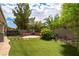 Serene backyard oasis with lush greenery, custom water features, and inviting patio space at 10381 Walking View Ct, Las Vegas, NV 89135