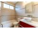 Modern bathroom featuring a vanity sink, bathtub, and tiled walls at 10381 Walking View Ct, Las Vegas, NV 89135