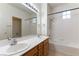 Bright bathroom features a double vanity, bathtub, and shower combination at 10381 Walking View Ct, Las Vegas, NV 89135