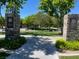 Entrance to community park featuring stone signage, mature trees, and a welcoming walkway at 10381 Walking View Ct, Las Vegas, NV 89135