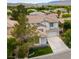 Inviting two-story home with an attached two-car garage, manicured lawn, and beautiful desert landscaping at 10381 Walking View Ct, Las Vegas, NV 89135