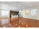 Open-concept living room with hardwood floors and a partial view of the kitchen at 10381 Walking View Ct, Las Vegas, NV 89135