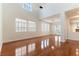 Bright living room featuring hardwood floors, high ceilings, and large windows at 10381 Walking View Ct, Las Vegas, NV 89135