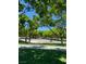 Scenic park view with lush green trees, grass, walkways, benches, and covered areas, offering a tranquil outdoor space at 10381 Walking View Ct, Las Vegas, NV 89135