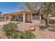 Private backyard featuring a covered patio and desert landscaping, perfect for outdoor living at 10547 Grazia Ave, Las Vegas, NV 89135