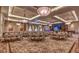 Elegant banquet hall with tables set beneath ornate chandeliers and decorative carpeting at 10547 Grazia Ave, Las Vegas, NV 89135