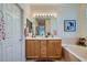 Bright bathroom with double sinks, wood cabinets, and a large mirror at 10547 Grazia Ave, Las Vegas, NV 89135