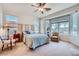 Bright bedroom features a ceiling fan and large windows showcasing outdoor views at 10547 Grazia Ave, Las Vegas, NV 89135