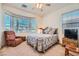 Cozy bedroom with a comfortable bed, soft lighting, and ample natural light at 10547 Grazia Ave, Las Vegas, NV 89135