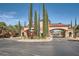 Welcoming community entrance with beautiful landscaping and a secure gate at 10547 Grazia Ave, Las Vegas, NV 89135