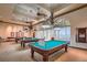 Elegant game room with multiple billiard tables and decorative lighting fixtures at 10547 Grazia Ave, Las Vegas, NV 89135