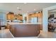 Bright kitchen with a center island, wooden cabinetry, and modern appliances at 10547 Grazia Ave, Las Vegas, NV 89135