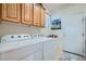 Convenient laundry room with washer, dryer, and ample cabinet space at 10547 Grazia Ave, Las Vegas, NV 89135