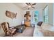 Cozy sitting room with traditional decor, complemented by a ceiling fan and natural light at 10547 Grazia Ave, Las Vegas, NV 89135