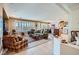 Spacious living room with tile flooring, plantation shutters, and an open floor plan at 10547 Grazia Ave, Las Vegas, NV 89135