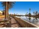 Picturesque pond with palm trees and outdoor seating with beautiful community views at 10547 Grazia Ave, Las Vegas, NV 89135