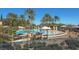Stunning community pool surrounded by lush landscaping and comfortable lounge seating at 10547 Grazia Ave, Las Vegas, NV 89135