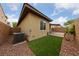 Backyard with paver patio, synthetic grass, and A/C unit, perfect for outdoor living at 10664 Mount Jefferson Ave, Las Vegas, NV 89166