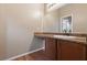 Bathroom vanity with a granite countertop, dark wood cabinets, and modern fixtures at 10664 Mount Jefferson Ave, Las Vegas, NV 89166