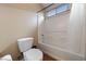 This bathroom features a shower over tub with white surround, a toilet, and a small window at 10664 Mount Jefferson Ave, Las Vegas, NV 89166