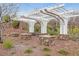 Charming community pergola with stone accents, bench seating, manicured landscaping and brick pathways at 10664 Mount Jefferson Ave, Las Vegas, NV 89166