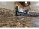 Close up on granite countertop and black range top at 10664 Mount Jefferson Ave, Las Vegas, NV 89166