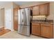 Modern kitchen featuring stainless steel refrigerator and granite countertops at 10664 Mount Jefferson Ave, Las Vegas, NV 89166