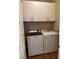 The laundry room has a washer and dryer and is fitted with overhead cabinet storage at 10664 Mount Jefferson Ave, Las Vegas, NV 89166