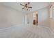 This main bedroom has carpeted floors and offers an ensuite bathroom with wood-look floors at 10664 Mount Jefferson Ave, Las Vegas, NV 89166