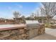 Community outdoor kitchen featuring a large grill and stone countertop, perfect for entertaining guests at 10664 Mount Jefferson Ave, Las Vegas, NV 89166