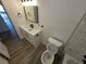 This renovated bathroom includes a modern vanity, toilet and tub with shower at 1083 E Calvada Blvd, Pahrump, NV 89048