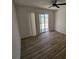 Bright bedroom boasts modern floors and a sliding glass door to the yard at 1083 E Calvada Blvd, Pahrump, NV 89048