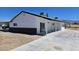 Exterior shot showcasing the covered parking, long driveway, and well-maintained yard at 1083 E Calvada Blvd, Pahrump, NV 89048