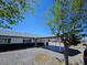 Exterior side view of this single story home with a porte cochere and desert landscaping at 1083 E Calvada Blvd, Pahrump, NV 89048