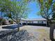 Charming home with xeriscaped front yard, covered parking, and mature trees at 1083 E Calvada Blvd, Pahrump, NV 89048