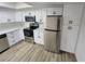 Updated kitchen features stainless steel appliances, white cabinets, and quartz countertops at 1083 E Calvada Blvd, Pahrump, NV 89048