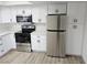 Updated kitchen features stainless steel appliances, white cabinets, and quartz countertops at 1083 E Calvada Blvd, Pahrump, NV 89048