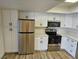 Bright kitchen boasts white cabinets, stainless steel appliances, and modern finishes at 1083 E Calvada Blvd, Pahrump, NV 89048