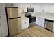 Updated kitchen boasts stainless steel appliances, modern white cabinetry, and quartz countertops at 1083 E Calvada Blvd, Pahrump, NV 89048
