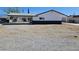A back exterior view of a single story home featuring the back yard and porte cochere at 1083 E Calvada Blvd, Pahrump, NV 89048