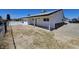 Exterior view of the backyard and patio area showcasing a single story property with a black trim at 1083 E Calvada Blvd, Pahrump, NV 89048