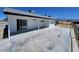 Rear exterior of this single story home featuring a back patio and black brick trim at 1083 E Calvada Blvd, Pahrump, NV 89048