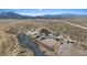 Sweeping aerial view of the expansive desert property featuring a home, stables, and riding areas at 11875 Maggie Ave, Las Vegas, NV 89166