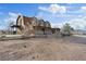 Charming two-story ranch-style home featuring a balcony and porch areas with natural stone accents in a rural setting at 11875 Maggie Ave, Las Vegas, NV 89166