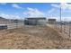 Outdoor horse shelter in sandy lot with a water tank and a building in the background at 11875 Maggie Ave, Las Vegas, NV 89166