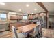 Well-equipped kitchen featuring custom cabinetry, stainless steel appliances, and a dining table at 11875 Maggie Ave, Las Vegas, NV 89166