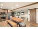 Rustic kitchen with stainless steel appliances, wood table and chairs, and barn door at 11875 Maggie Ave, Las Vegas, NV 89166
