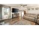 Open living room with a large window, hardwood floors, and comfortable sofa at 11875 Maggie Ave, Las Vegas, NV 89166