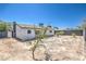 View of the back of the house and large backyard with block wall fencing at 4012 Mira Ln, Las Vegas, NV 89108